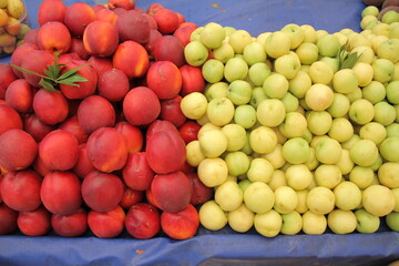 Yellow nectarine fruit and peach fruit on the market stall.