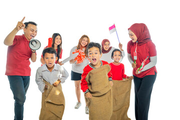 A group of people are posing for a picture of a sack race contest, with one man holding a megaphone