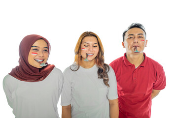 Three people with spoons are marble racing, one of them is wearing a red scarf