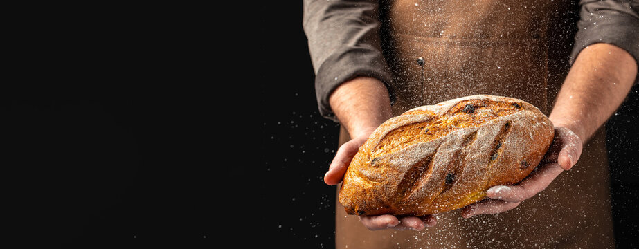 Homemade gluten free bread in men's hands. Long banner format. copy space for text