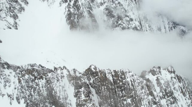 Aerial View of Snow Capped Hills and Peaks of Alps on Cold Winter Day