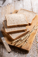 Healthy wholemeal bread slices on rustic wooden table