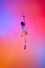 Top-down view of fencer in action, lunging with his epee performing his power and strength during...