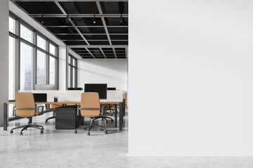Modern office workspace with desks and chairs, large windows, and a light background. Concept of a contemporary work environment. 3D rendering