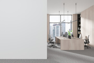 Contemporary office with shared desks, chairs, and large window. Minimalist design. Light carpeted floor and light wood elements. Collaborative workspace. 3D rendering