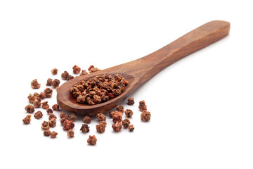 Front view of a wooden spoon filled with dry Organic Beetroot (Beta vulgaris) seeds. Isolated on a white background.
