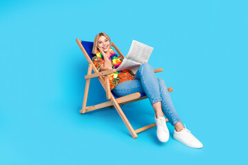 Photo of positive cheerful girl wear trendy print clothes read news sale shopping weekend isolated on blue color background © deagreez