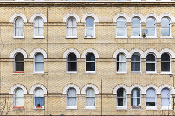Facade of Georgian style apartment with arched windows in London