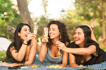 girlfriends smiling being happy at the park with a drink