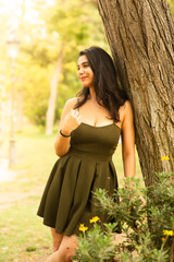 young woman relaxing in the park with beautiful smile dreaming dreamy