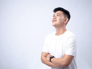 A young Asian man, wearing a white shirt and black watch, smiles confidently with his arms crossed. The background is plain white, highlighting the subject's professional and approachable demeanor