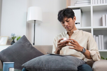 Stressed Man Taking Medicine at Home for Stress Relief and Health Management in a Modern Living Room
