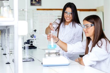 Two women working in a laboratory with equipment. © zorandim75