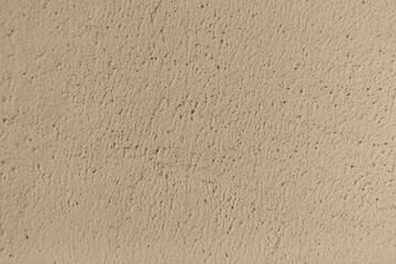 The background of the wall is uneven and painted with light beige paint. Over time, the protruding parts have become dusty, the workpiece is a sample of aging and dust settling