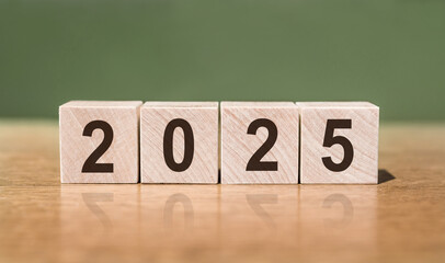 Wooden Blocks Spelling Out The Year 2025 On A Tabletop