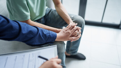 sad male sitting on sofa Patient discussing mental health issues with psychologist. depressed asian man mental health treatment