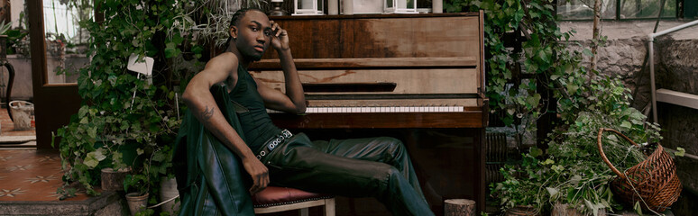 African american man in elegant attire plays piano.