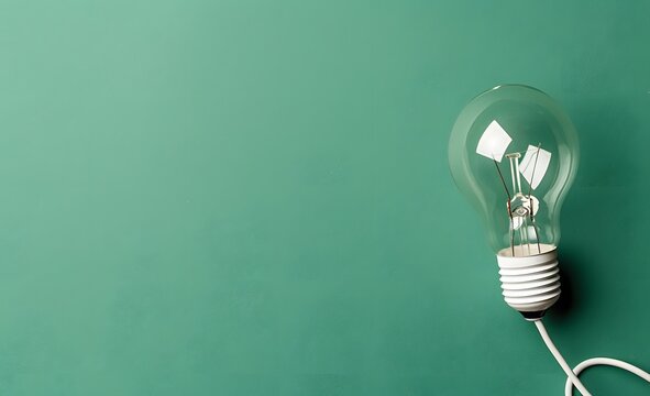 Light Bulb on Green Background with Copyspace