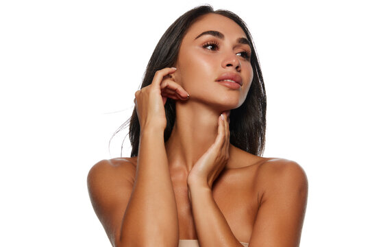 Face building massage. Portrait of beautiful young woman with perfect face lines, tanned spotless skin isolated on white background. Female beauty, skin and body care, cosmetology, cosmetics concept