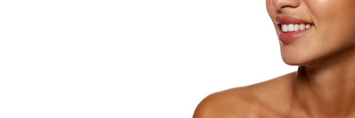 Obraz premium Cropped image of female face, perfect chick, plump lips and white teeth, woman smiling isolated on white background. Concept of female beauty, skin and body care, cosmetology and cosmetics. Banner