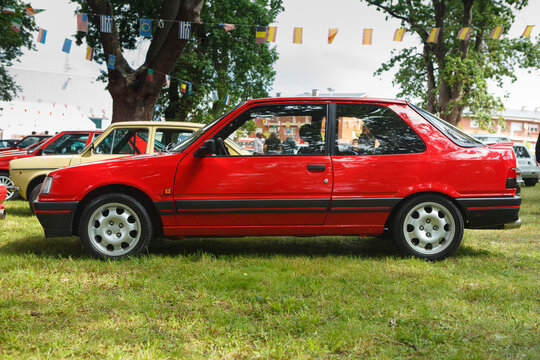 Classic red Peugeot 309 GTI during an open-air classic car exhibition