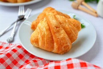 Mini croissant in white plate on white table