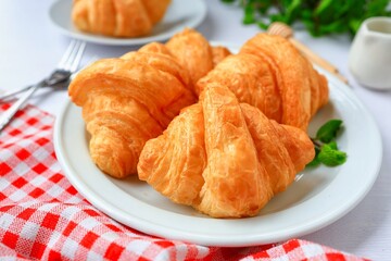 Mini croissant in white plate on white table