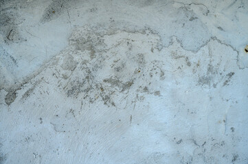 Close-up. Badly fixed building facade wall covered with cracks in stucco and paint