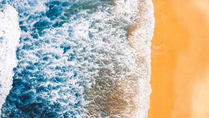 Waves on an orange sand beach