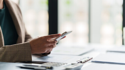 Fototapeta premium Businesspeople thoughtful using smartphone browsing internet