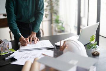 Interior architect or engineer working on blueprint at office