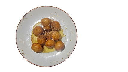 loukoumades with honey in the plate