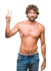 Fototapeta premium Handsome hispanic model man sexy and shirtless over isolated background showing and pointing up with fingers number two while smiling confident and happy.