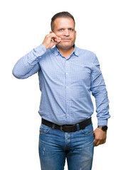Middle age arab business man over isolated background mouth and lips shut as zip with fingers....