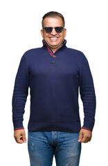 Middle age arab man wearing sunglasses over isolated background with a happy and cool smile on face. Lucky person.