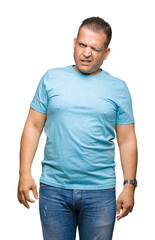 Fototapeta premium Middle age arab man wearing blue t-shirt over isolated background winking looking at the camera with sexy expression, cheerful and happy face.