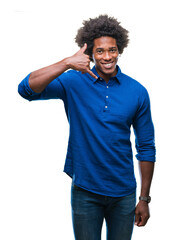 Afro american man over isolated background smiling doing phone gesture with hand and fingers like talking on the telephone. Communicating concepts.