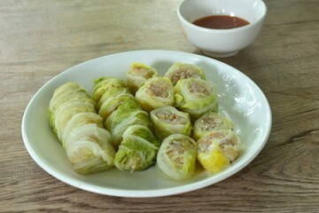 steamed Chinese cabbage stuffed chop pork and glass noodles on plate dipping sukiyaki sauce