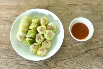 steamed Chinese cabbage stuffed chop pork and glass noodles on plate dipping sukiyaki sauce