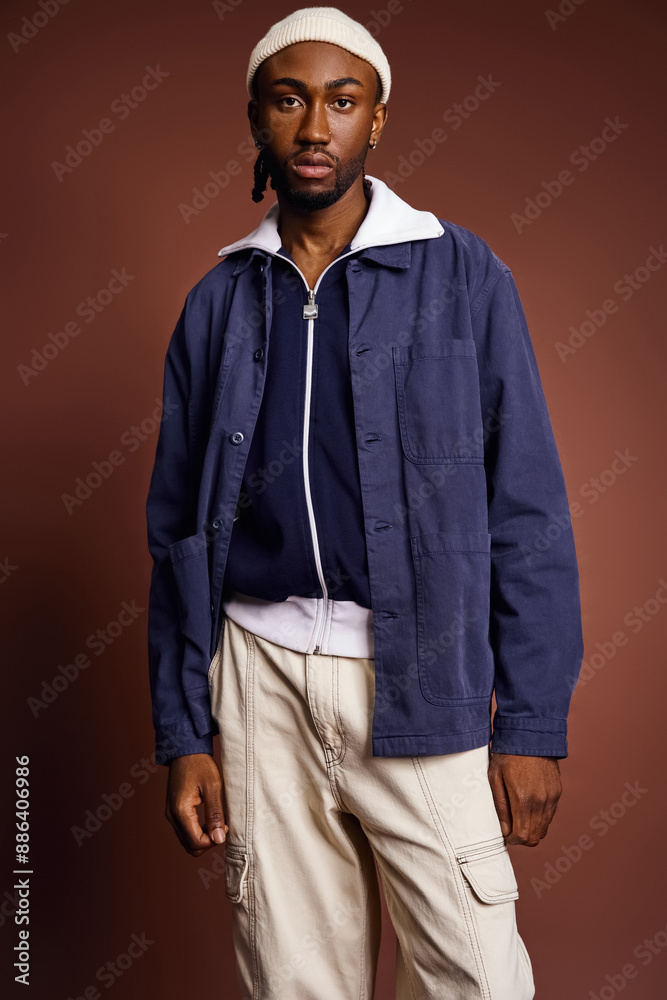 Wall mural A handsome young African American man in a blue jacket and tan pants.