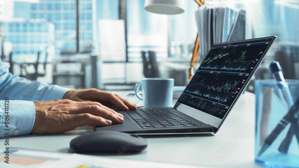 Poster Close-Up On Hands Of Professional Broker Using Laptop Computer With Stock Options Graphs And Charts On Screen. Man Analyzing Stock Market Data And Enjoying Coffee In Hedge Fund Office.