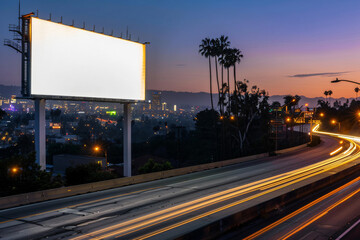 photo of blank billboard near busy highway at evening, city lights,