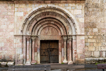 Fototapeta premium Villefranche, France, 05-24-2024. Entrance porch of the church of the city of Villefranche de conflent, France.