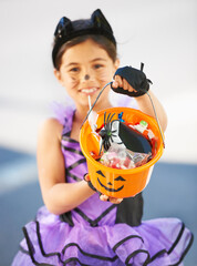 Halloween, child or trick and treat bucket portrait outdoor in neighborhood for fun and dress up. A...