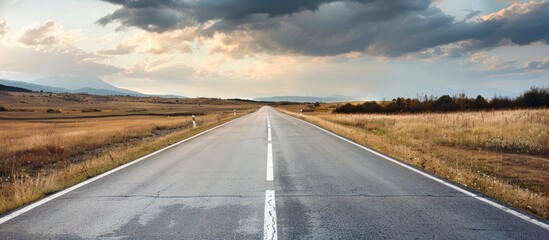 A long highway stretching infinitely offering a serene and limitless path ahead with copy space image