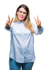 Young beautiful business woman wearing glasses over isolated background smiling looking to the camera showing fingers doing victory sign. Number two.