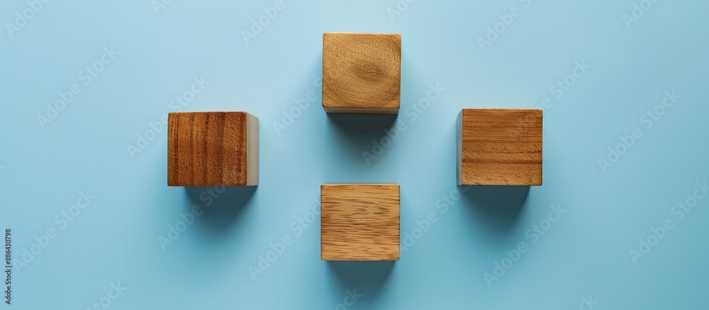 Poster a bird s eye view of three empty wooden cubes on a blue backdrop with copy space image