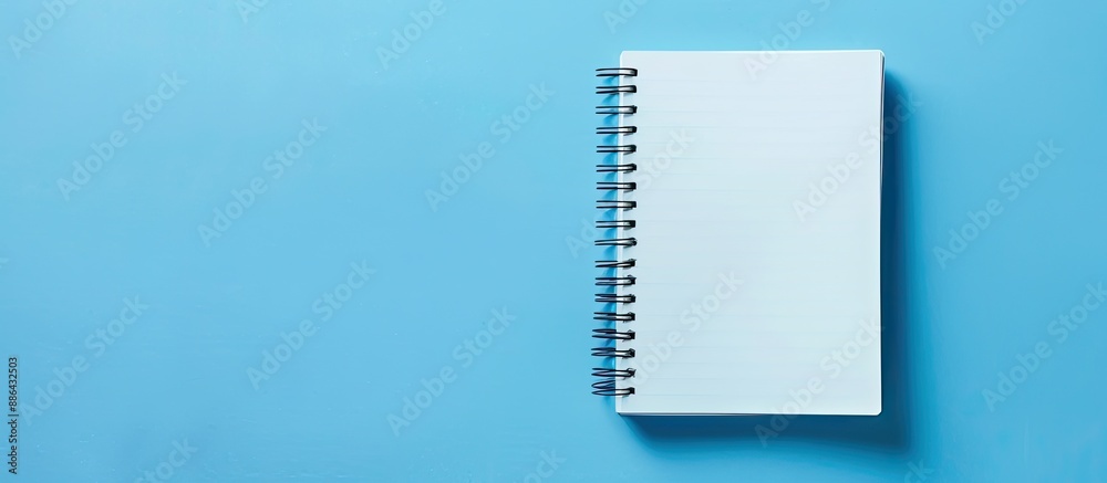 Poster blue paper with a blank notebook page ideal for business with copy space image