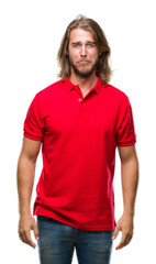 Young handsome man with long hair over isolated background depressed and worry for distress, crying angry and afraid. Sad expression.