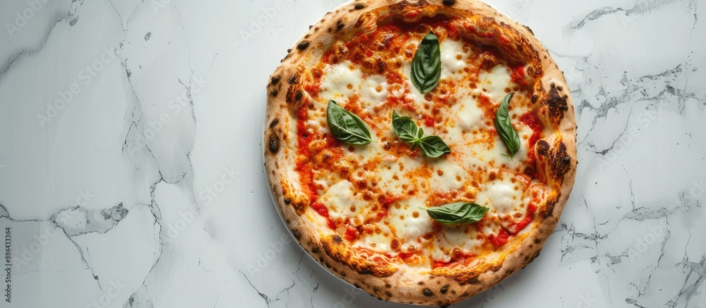 Fototapete Top view of a traditional Italian pizza topped with cheese set on a white marble surface with room for text or images in the frame. with copy space image. Place for adding text or design